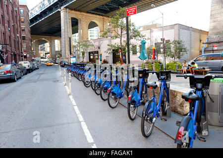 Rental bicycles under the Manhattan Bridge in the DUMBO nieghborhood of Brooklyn New York City Stock Photo