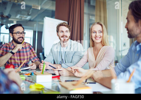 Business team looking at their boss speaking about working plans Stock Photo