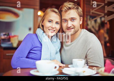 Happy young couple relaxing in cafe Stock Photo