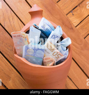 Euro notes in broken clay piggy bank Stock Photo