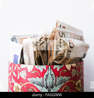 Euro currency notes (fifties and twenties) in round cardboard box Stock Photo