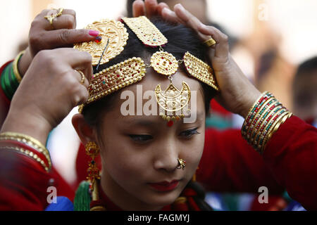 Kathmandu, Nepal. 30th Dec, 2015. Nepalese women arrange ornaments of a girl during Tamu Losar festival in Basantapur, Kathmandu, Nepal on Wednesday, December 30, 15. Tamu is another name of Gurung and Losar means New Year. Tamu Losar is the celebration for New Year of the Gurung community. Credit:  Skanda Gautam/ZUMA Wire/Alamy Live News Stock Photo