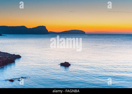 Sunrise over the calm beautiful water in Es Canar, Ibiza, part of the Balearic Islands in Spain,Europe. Stock Photo