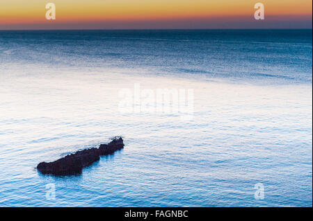 Sunrise over the calm beautiful water in Es Canar, Ibiza, part of the Balearic Islands in Spain,Europe. Stock Photo