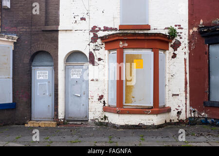 A boarded up house in Liverpool 8 has metal screens on doors and windows to deter vandals and thieves. Liverpool council owns Stock Photo