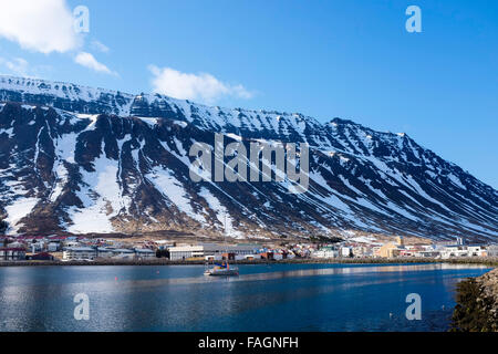 The town of isafjordur against the dramatic hills and mountains behind in the west Fjords of northern Iceland Stock Photo