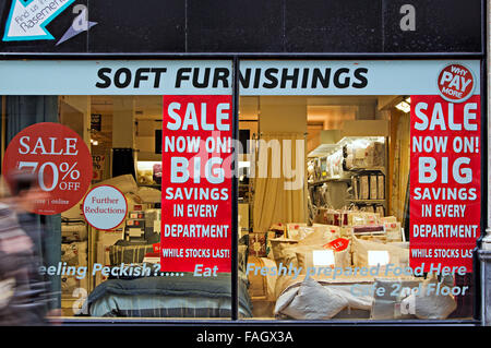 Big savings posters in a soft furnishing store window display Stock Photo