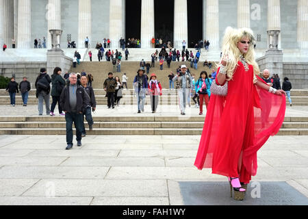 A transsexual walks across the concourse in front of the Lincoln Memorial, Washington watched by a crowd of  fascinated tourists Stock Photo