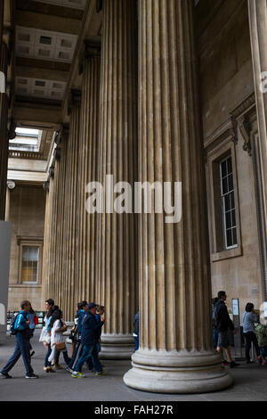 Tourists and visitors climb the stairs at the entrance of the British Museum in London, one of the most important museums in UK Stock Photo