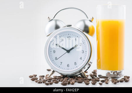 Alarm clock and fresh juice on the surface Stock Photo