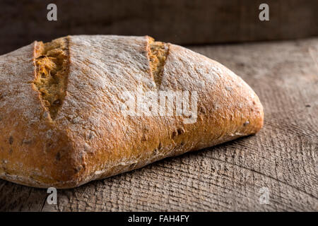 Bread rye on an old wooden background Stock Photo