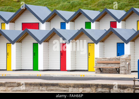 New colourful beach huts, colorful beach huts, along the promenade at Swanage, Dorset UK in May Stock Photo