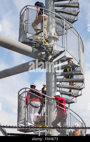 Climbing up spiral staircase to the top of the launch tower to try out the pier zipwire on Bournemouth Pier, Dorset in April Stock Photo