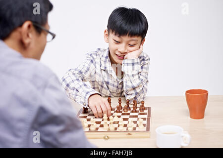 father and son playing chess Stock Photo