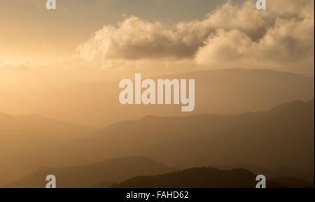 Dramatic and idyllic sunset with bright orange and yellow vibrant colors Stock Photo