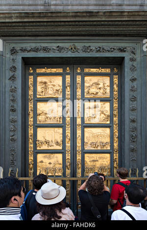 FLORENCE - AUGUST 16: Tourists in front of Golden Door of the Florence Baptistery (Battistero di San Giovanni) on August 16, 201 Stock Photo