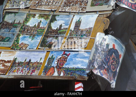 Self portraits and landscapes by Czech naive street artist Antonin 'Tonda' Votava, also known as the Devil from the Charles Bridge, on sale on the Charles Bridge in Prague, Czech Republic, on June 8, 2003. Antonin Votava (1943 - 2009) worked as a street artist on the Charles Bridge for almost 40 years from 1969 until his death on October 22, 2009. His trademark red horns and tongue made him the living symbol of the Charles Bridge. Stock Photo