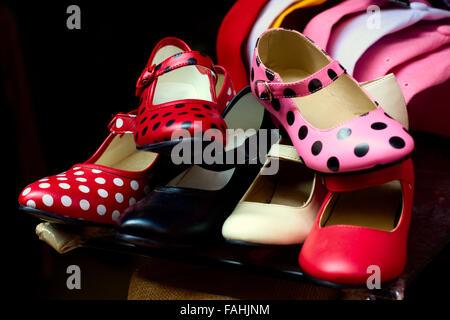 Typical Spanish gypsy shoes (red, pink, black and white) with polka dot spots in shop market. Colorful flamenco shoes. Stock Photo
