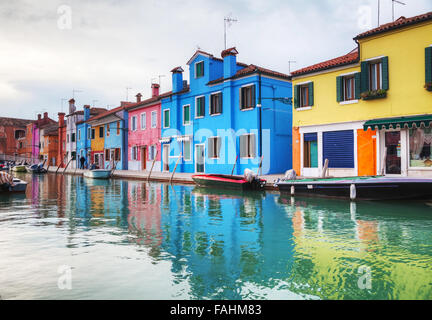 BURANO, ITALY - NOVEMBER 23: Brightly painted houses at the Burano canal on November 23, 2015 in Burano, Venice, Italy. Stock Photo