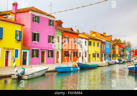 BURANO, ITALY - NOVEMBER 23: Brightly painted houses at the Burano canal on November 23, 2015 in Burano, Venice, Italy. Stock Photo