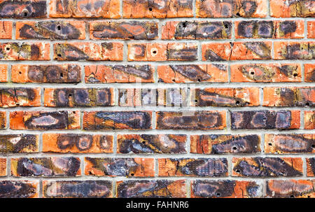 Weathered stained old red brick wall as background Stock Photo