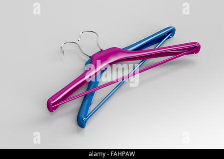 Purple and blue coat hangers on gray background Stock Photo
