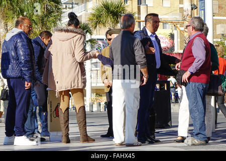 Pea men, peamen, shell men, con men, most of the people in this picture are part of the game to trap tourists in Benidorm Stock Photo