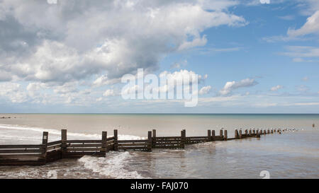 Breaking waves on a flat calm sea Stock Photo