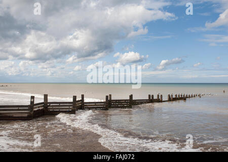 Breaking waves on a flat calm sea Stock Photo
