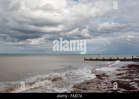 Breaking waves on a flat calm sea Stock Photo