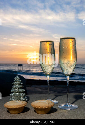 Champagne mince pies at Christmas by sea at sunrise Stock Photo