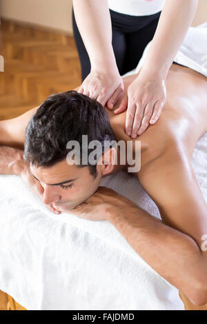 Handsome young man lying and having back massage in spa salon during winter  season 2007521 Stock Photo at Vecteezy