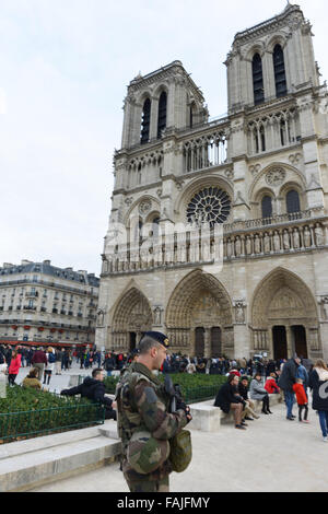 Paris. 30th Dec, 2015. A soldier stands guard in front of Notre Dame in Paris, France, Dec. 30, 2015, as France tightened the security ahead of the New Year celebrations. Credit:  Li Genxing/Xinhua/Alamy Live News Stock Photo