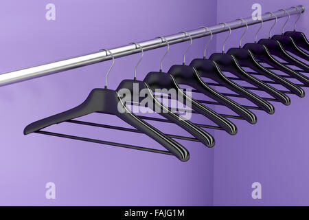 Plastic hangers hanging on rod in the closet Stock Photo