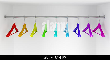 Rainbow colored hangers in the closet Stock Photo