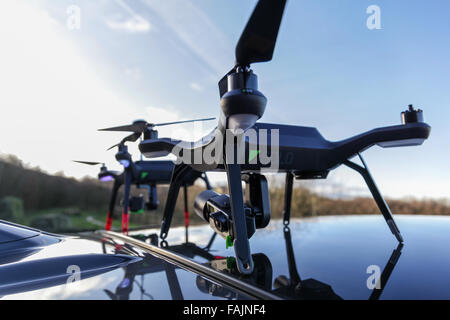 Drones ready to be deployed from the roof of a parked car. Stock Photo