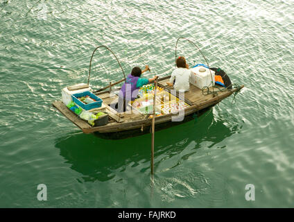 Floating market, Vietnamese selling colorful fruit from a rowing boat, Ha Long Bay, Vietnam, Southeast Asia Stock Photo