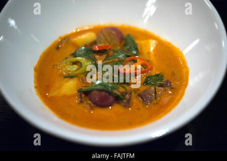 Thai food. Gaeng Phed Ped Yang Kub ar-ngoon. Red curry of roasted duck wirh grapes, pineapple and basil. Restaurant, Hotel, Shan Stock Photo