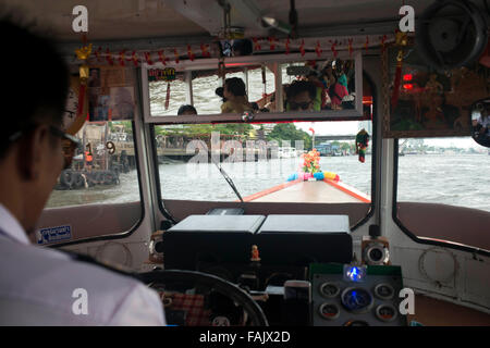 Chao Praya Express Boat driver. Bangkok, Inside public boat, ferry. Bangkok. Asia.  The Chao Phraya river makes a great way to g Stock Photo