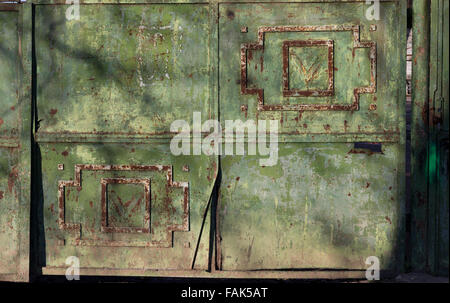 Grunge green metal door background. Part of a fence, used for industrial purposes Stock Photo