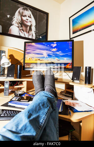 Feet on desk office worker relaxing in front of computer screen legs ...