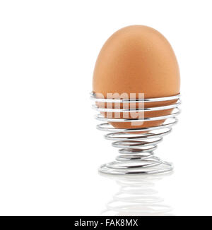 Boiled egg in silver spiral egg cup isolated on white background Stock Photo