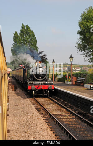 Steam train approaching Williton Station on the West Somerset Steam Railway. Stock Photo