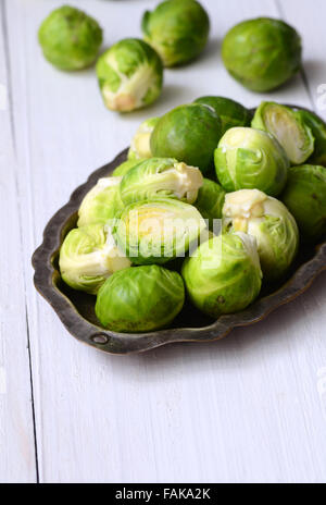 Fresh brussel sprouts on white wooden background Stock Photo