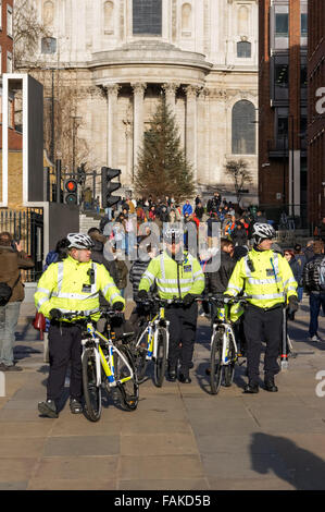 Police patrol on bicycles on the Millennium Bridge, London England United Kingdom UK Stock Photo