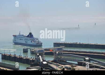 The Port of Dover is the cross-channel port situated in Dover, Kent, SE England. Here the port has a bank of sea mist or fog. Weather Stock Photo