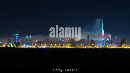 Dubai, United Arab Emirates. 31st Dec, 2015. Fireworks explode as smoke billows from the nearby Address Downtown Hotel which caught on fire hours earlier, near the Burj Khalifa, the world's tallest tower in Dubai, the United Arab Emirates, on Dec. 31, 2015. Fire broke out on Thursday in a luxurious hotel in Dubai where people were gathering nearby to watch the New Year's fireworks show. Credit:  Zhang Shumin/Xinhua/Alamy Live News Stock Photo