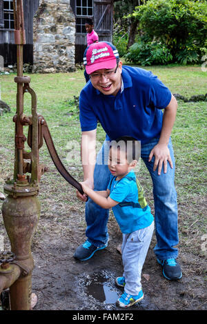 Gainesville Florida,Dudley Farm State Park,Homestead & Living History Museum,property,Asian man men male,father,boy,son,water pump,well,pumping,teamwo Stock Photo