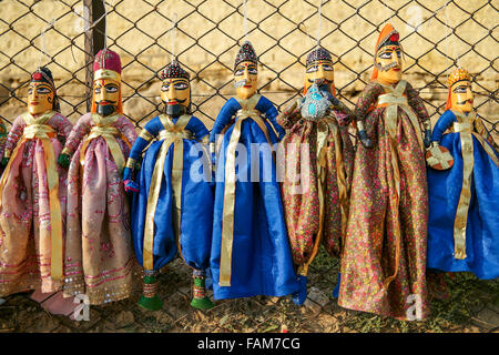 Colorful Rajasthan puppets hanging in the shop of Gadhisar Lake in Jaisalmer, India. Stock Photo