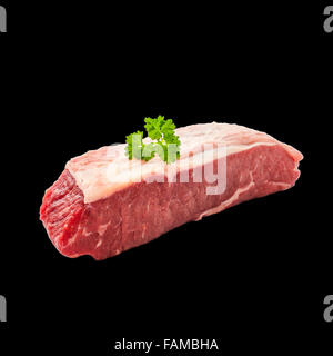 Raw rump steak with parsley twig isolated on black Stock Photo